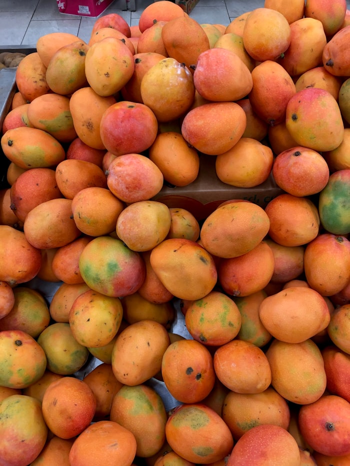 Sun-ripened mangoes stacked in a crate